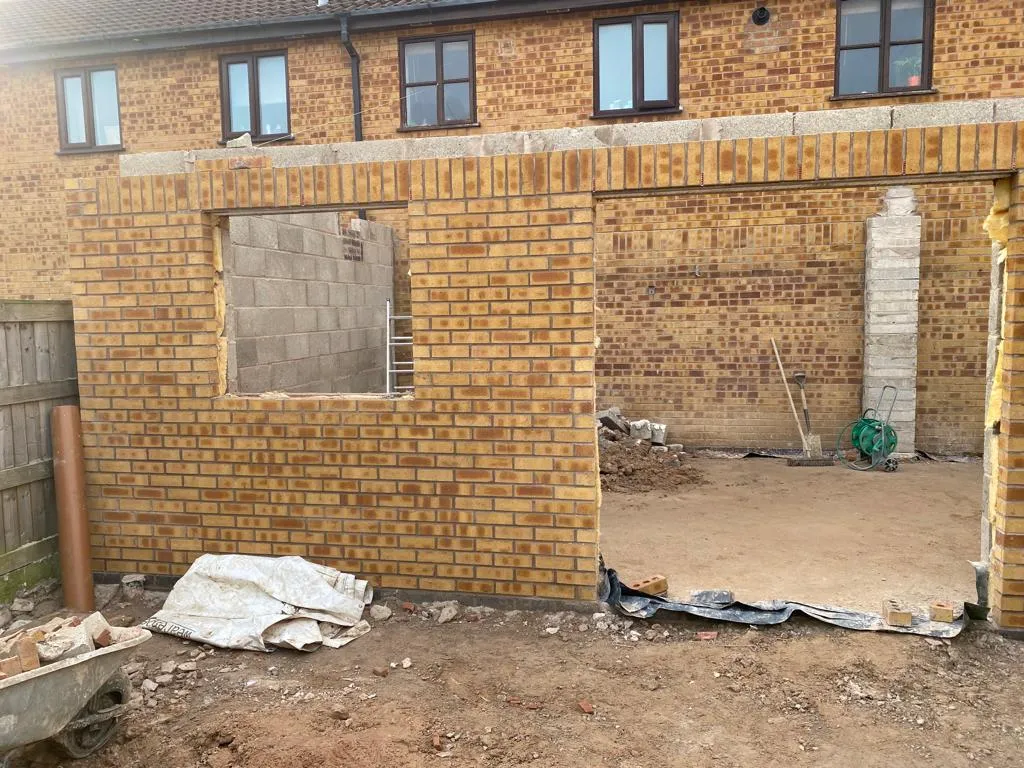 A brick building with a door and windows.