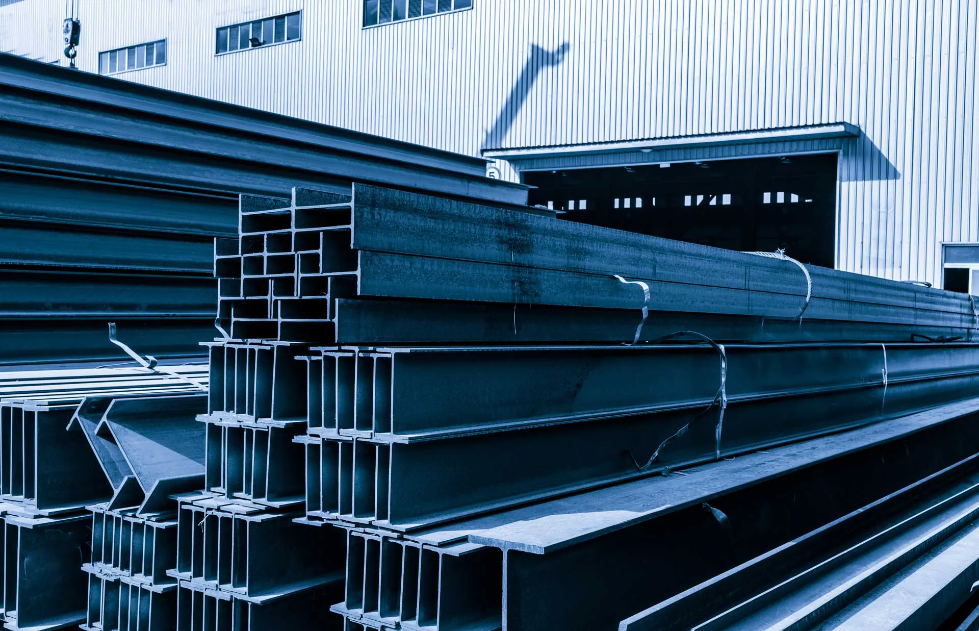 A stack of steel bars in front of a building.